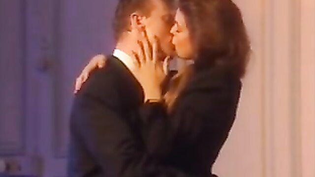 Vintage 1991 couple kissing passionately in suits, Potere movie