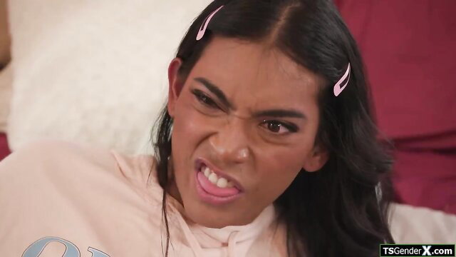 Expressive latina shemale with pink hair clips smirks seductively