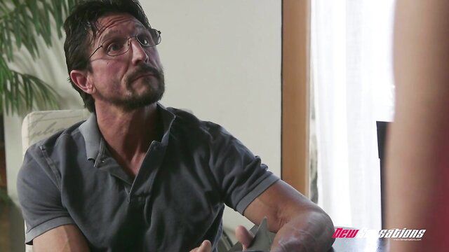Handsome mature Latino man in polo shirt, intense gaze in adult scene