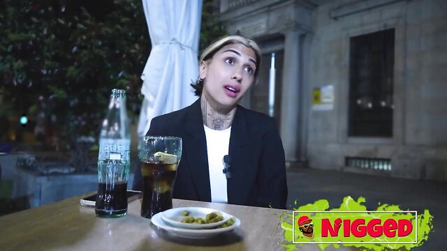 Valeria Del Rio blonde tattooed model sipping Coke at outdoor table