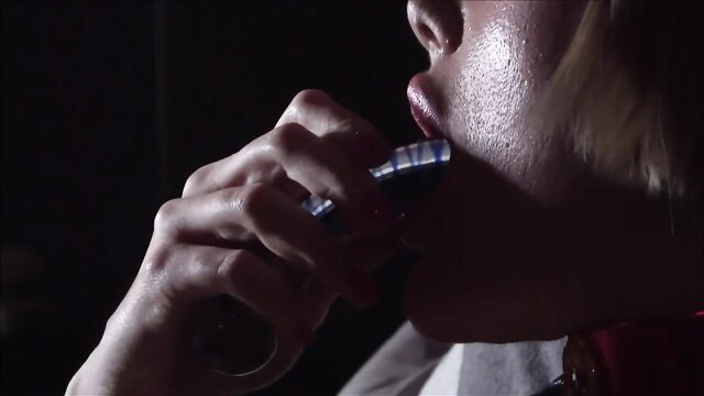 Kitty Catherine holds blue dildo in mouth, closeup lips tease toy