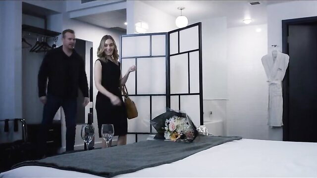 Shelby Handley as Zoe Ellison in black dress with flowers in hotel room