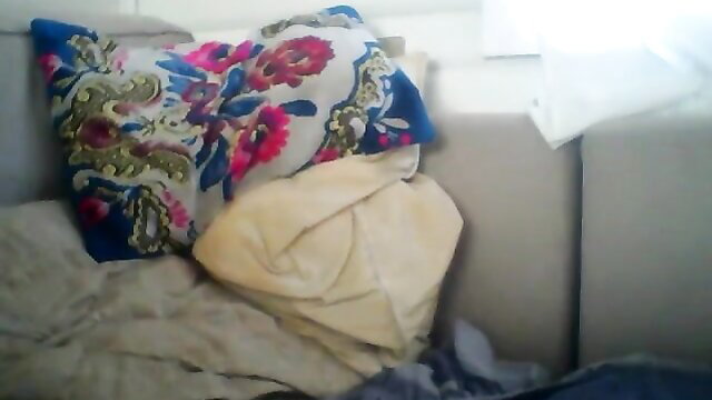 Colorful floral pillow on couch in hung webcam wanker setup