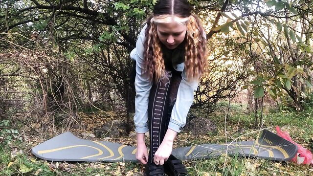Curly haired girl in stockings squats over dildo in public park