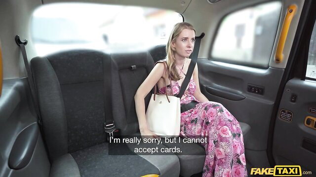 Adriana Sweetblonde with blonde hair in a pink dress inside a taxi cab