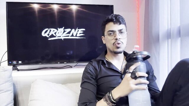 Handsome Indian guy in black shirt holding water bottle, social media talk thumbnail