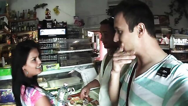 Busty Latina neighbor in pink top chats with men at store counter