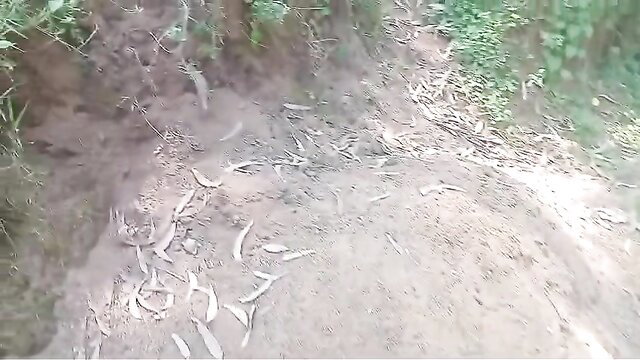 African YouTuber walking by river in lush green nature trail