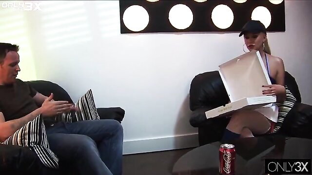 Blonde Carly Parker in lingerie holds open box with man on couch