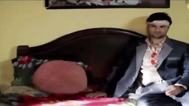 Man in suit and headband on bed in Sabak Ishq Ka Ullu hot web series