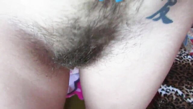 Super hairy bush closeup on woman with blue tattoo and leopard print