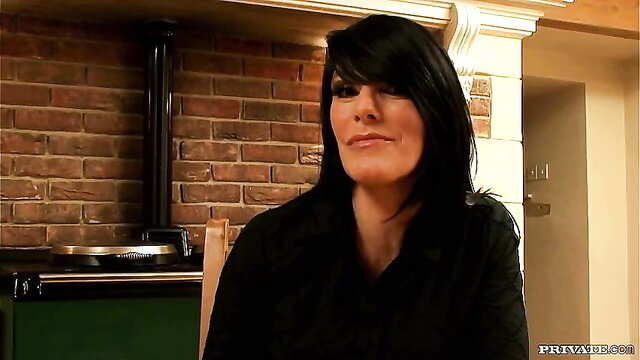 Big boobed brunette in kitchen smiling seductively