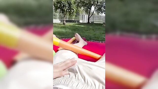 Horny young guy fucking hot woman outdoors on pink floatie