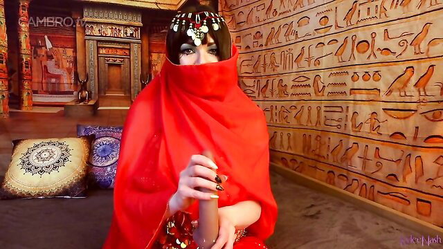 Charming MILF in red hijab veil holds thick dildo in Egyptian temple