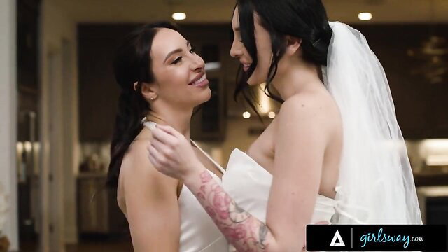 Charlotte Sins & Melissa Stratton in wedding dresses, intimate bride kiss