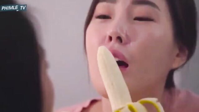Asian beauty sensually sucking banana closeup, teasing blowjob preview