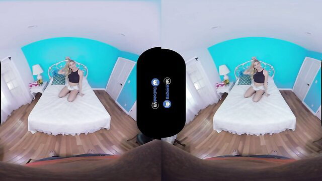 Jessa Rhodes blonde bombshell sitting topless on bed in VR porn
