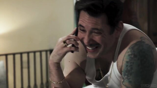 Sophia Locke laughing on phone in tank top, tattooed arm