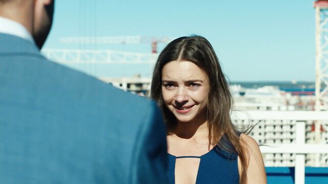 Vera Panfilova smiling in sexy navy dress rooftop scene