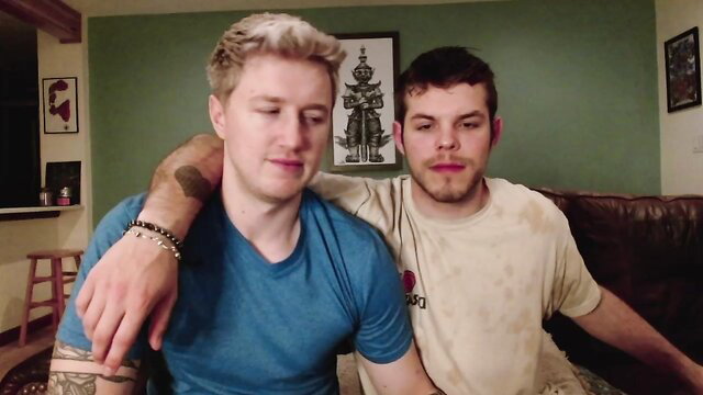 Two hot white guys cuddling intimately on couch in gay amateur video