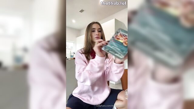 Natalie Roush in pink hoodie holding Momo cosplay book striptease