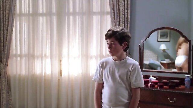 Boy in white tee stares at mirror reflection in Pajarico 1997 scene