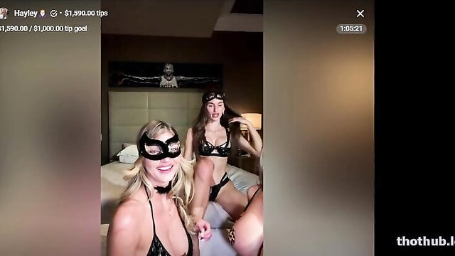 Lyna Perez and Hayley Maxfield in sexy black lingerie masks on bed
