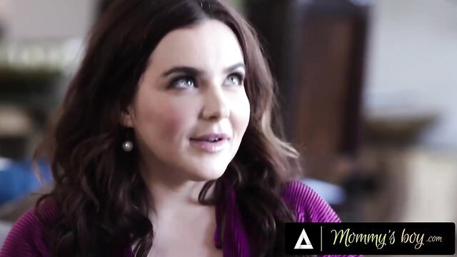 Hot brunette stepmom in purple sweater smiles seductively closeup