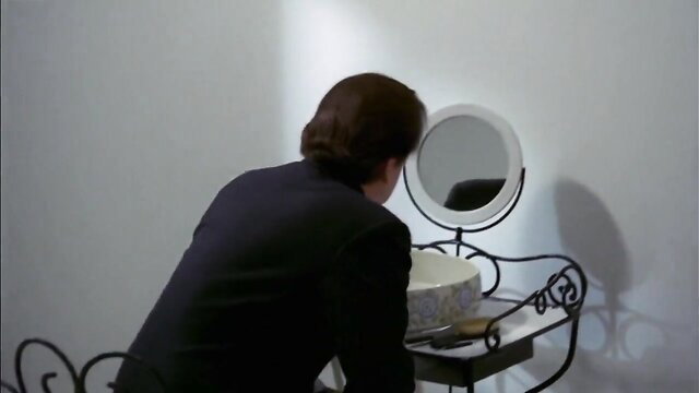 Anicee Alvina in elegant suit at vanity mirror, Glissements progressifs du plaisir
