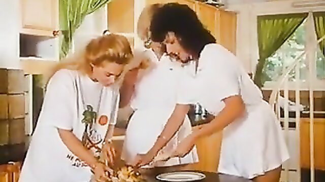 Marilyn Jess and blondes prepping food in kitchen, La Dechainee 1987