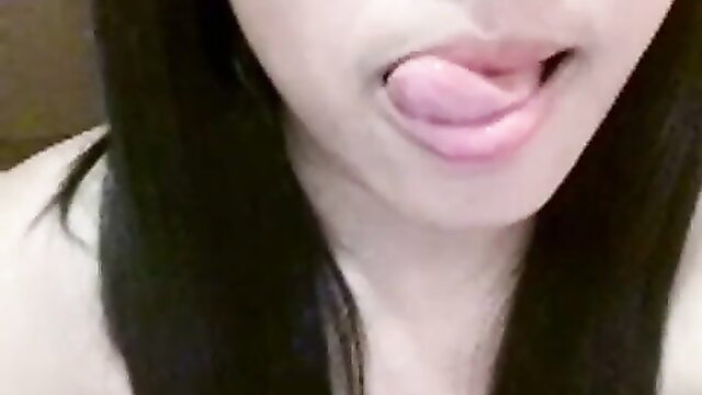 Beautiful Indonesian girl Natasya sticks out wet tongue closeup