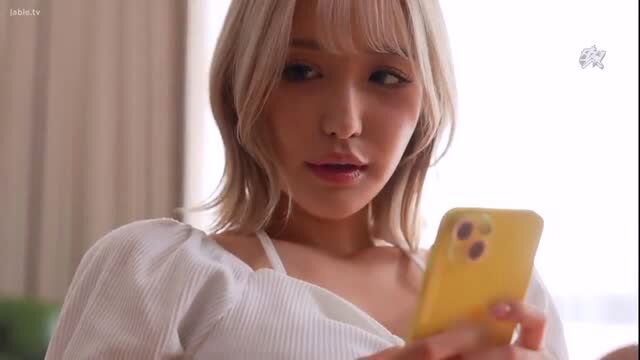Blonde Japanese babe Sarina Momona holds phone, big tits in puffy white top