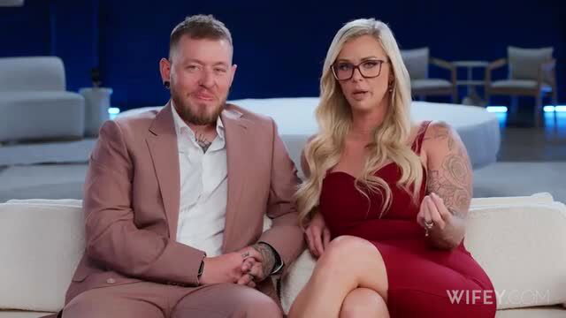 Kyle Stone & blonde tattooed wife Ashley in tight red dress on couch