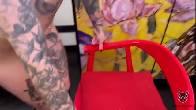 Mari Galore and tattooed boyfriend by red chair, nude teasing