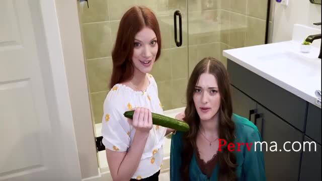 Redhead Erin Everheart holds huge cucumber to brunette Olivia Madison in bathroom