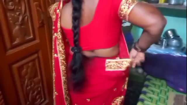 Indian housewife in red saree changing at home