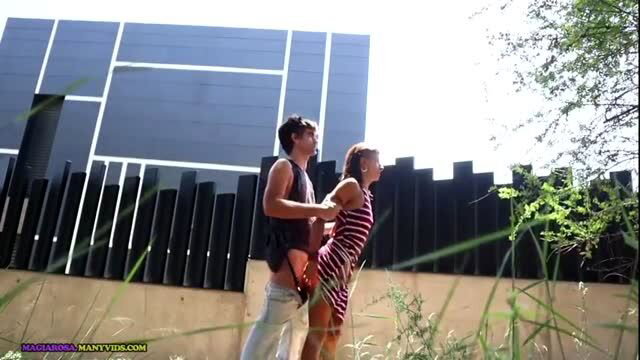 Couple having outdoor sex against a wall in daylight
