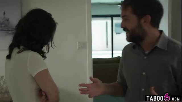 Casey Calvert in white top looking away from smiling bearded man