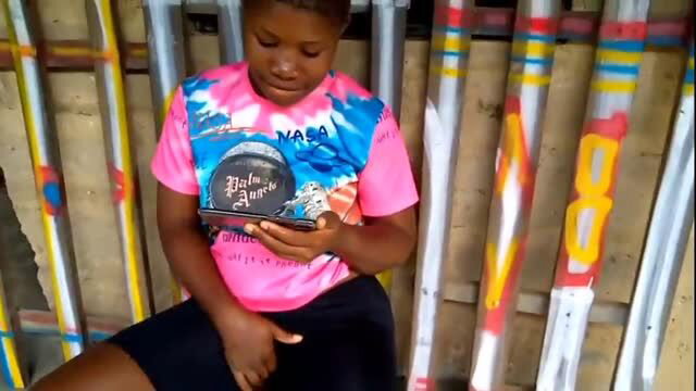 HafricanToto holding glass award in Christmas in My Village video