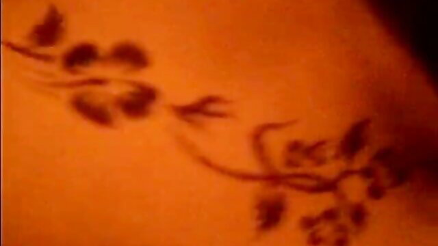 Closeup of mysterious floral branch tattoo on nude Asian woman's hip in JAV amateur