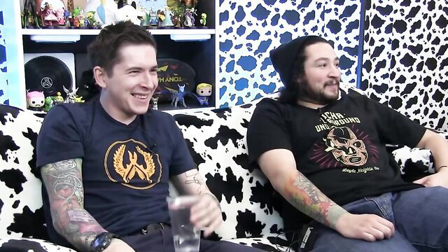 Two tattooed guys on couch in VR porn thumbnail