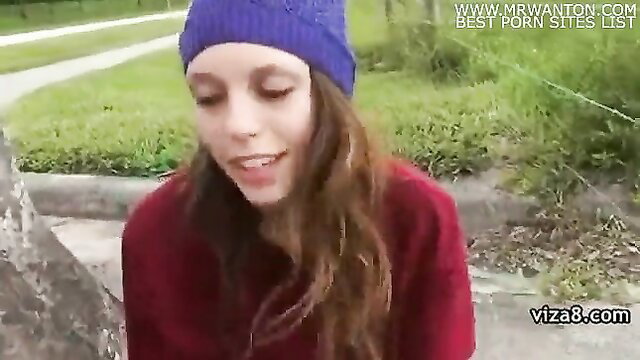Cute brunette teen in purple beanie smiles outdoor amateur closeup
