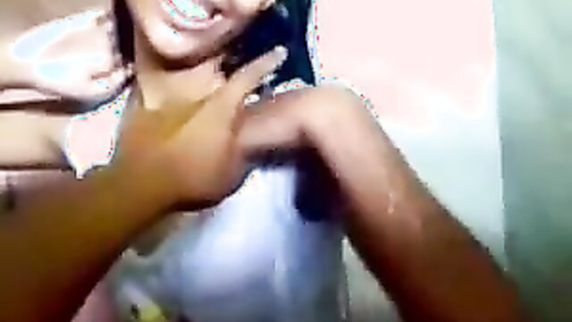 Hot Indian teen smiles naughtily with hands on neck in bathroom