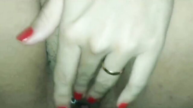 Closeup of wife's hand with red nails and wedding ring in ecstasy