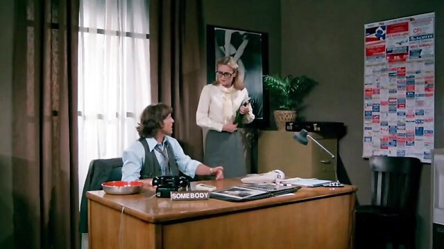 Vintage 70s babe in glasses and skirt seduces lover at office desk