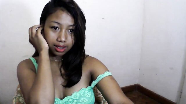 Asian beauty in sexy green lace off-shoulder dress, teasing closeup