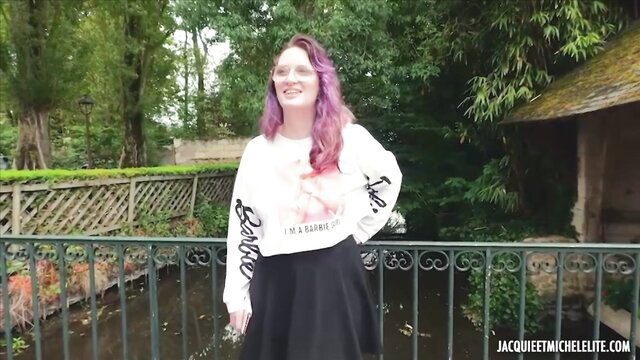 Purple-haired French babe in Barbie sweatshirt and skirt poses sexy outdoors