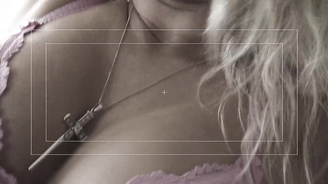 Blonde teen's huge tits in pink lingerie with cross necklace closeup