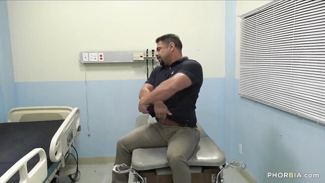 Draven Navarro arms crossed on exam table in BiPhoria bisexual scene