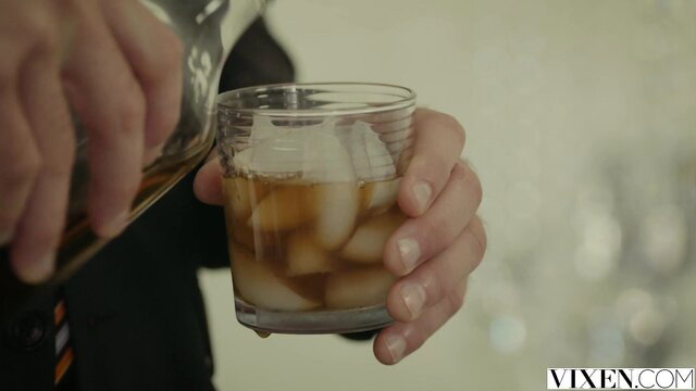 Man pours whiskey on ice glass in Vixen bar scene with Karla Kush